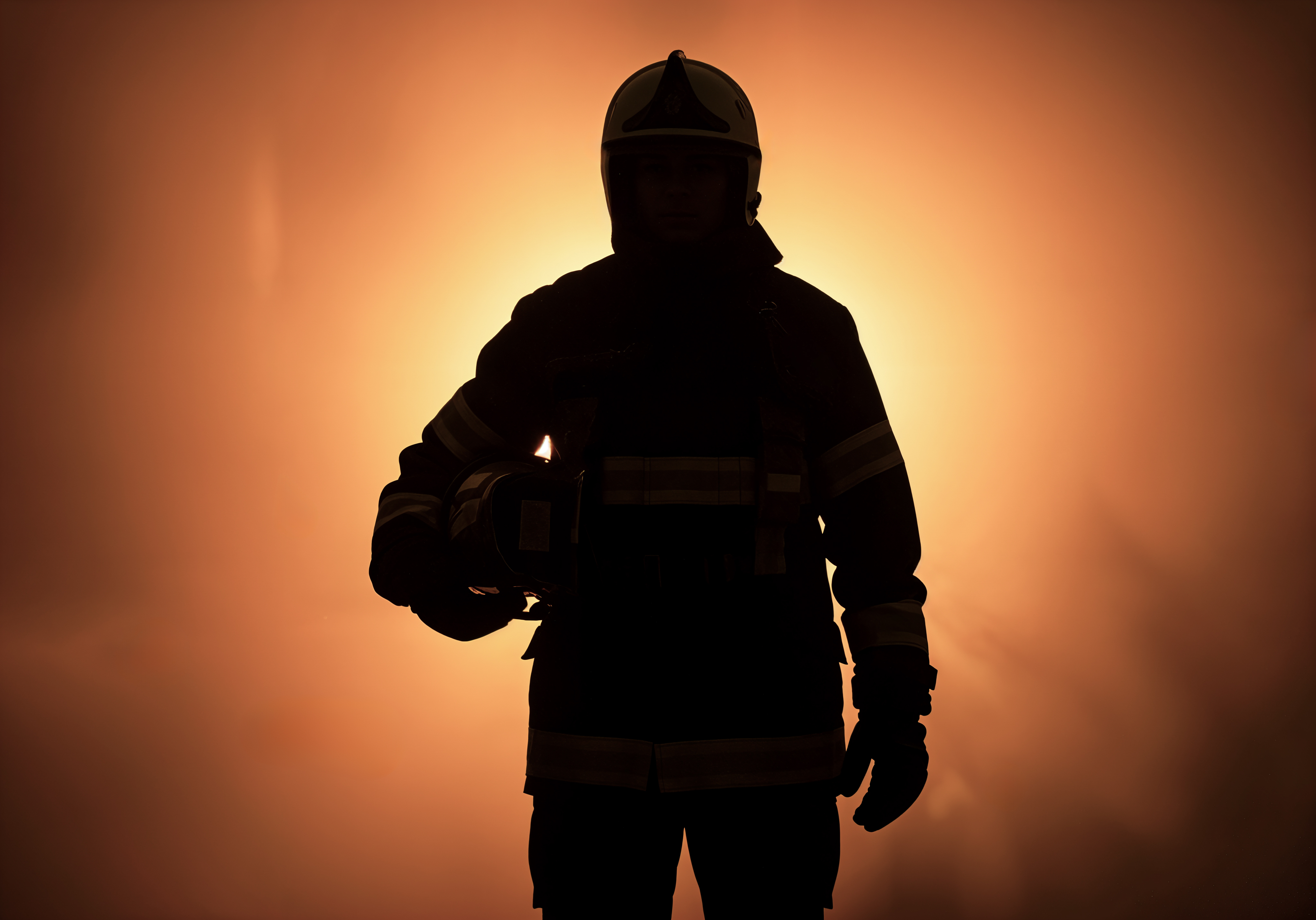 Firefighter silhouette in orange haze